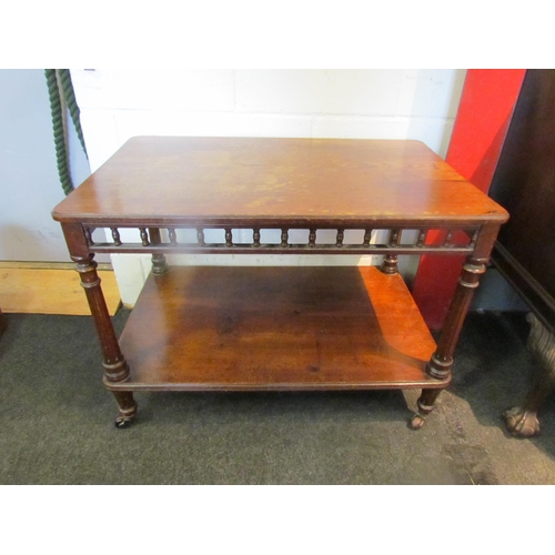 1088 - A late Victorian oak two tier serving table with spindle detail raised on castors, stains to top, 63... 