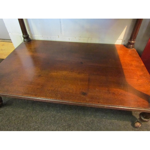 1088 - A late Victorian oak two tier serving table with spindle detail raised on castors, stains to top, 63... 