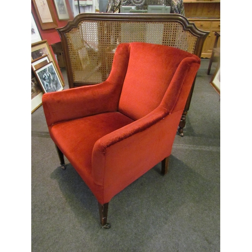 1097 - A red velour lady's armchair on castors