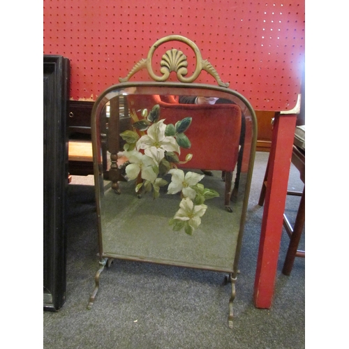 1108 - A heavy brass painted mirrored fire screen