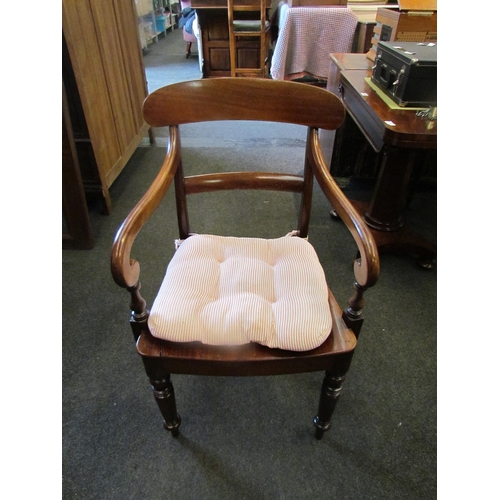 1125 - A Victorian mahogany elbow chair, scroll arms, solid seat, on turned legs, back rest a/f