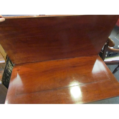 1129 - A Victorian mahogany tea table, the fold-over top over a scrolled frieze, to a faceted column, on qu... 