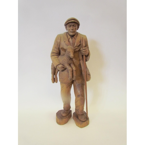 1174 - An Anton Wagner of Worstead carved wooden figure of farmer holding a lamb and cane, carved AW to bas... 