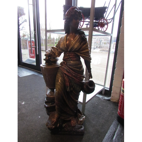 1177 - A plaster figure of a gypsy girl leaning on an urn holding jug, 98cm tall, badly damaged in need of ... 