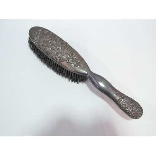 1252 - An embossed silver backed brush