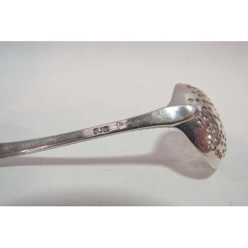 1279 - A Georgian silver sifter spoon with feather edge decoration and engraved crest.  Lion passant and ma... 