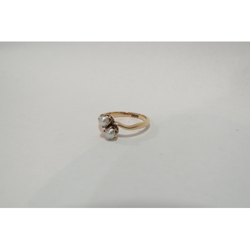 1295 - A pearl crossover ring, stamped 18ct. Size L, 2.6g  (C)