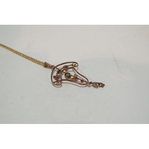 1301 - A 9ct gold chain hung with a seed pearl and green stone Art Nouveau style pendant, stamped 9ct, 4g  ... 