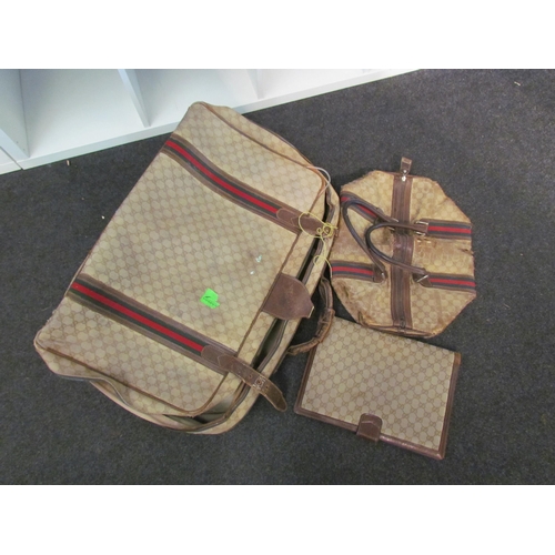 1415 - A vintage Gucci suitcase, bag and travel wallet, well used