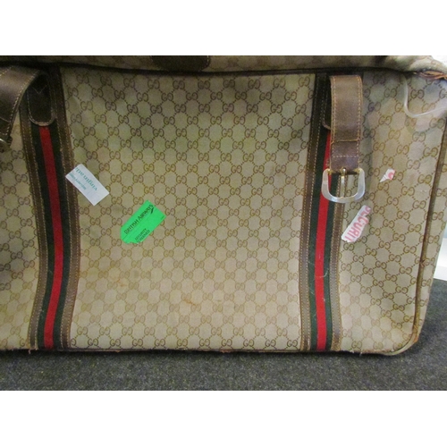 1415 - A vintage Gucci suitcase, bag and travel wallet, well used