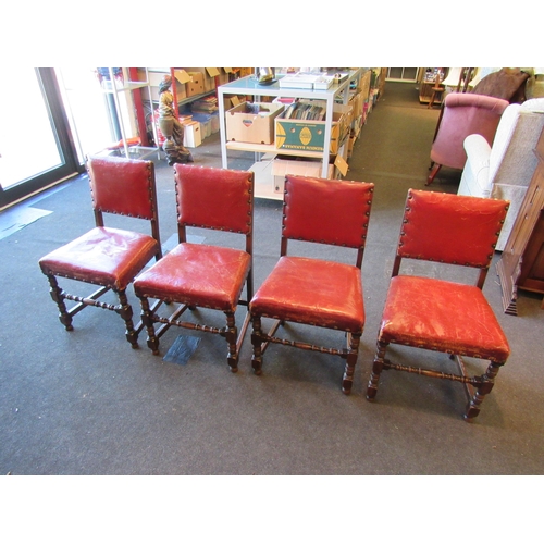 1024 - A set of four 1940's oak framed Cromwellian style dining chairs, studded upholstery