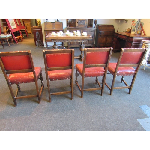 1024 - A set of four 1940's oak framed Cromwellian style dining chairs, studded upholstery