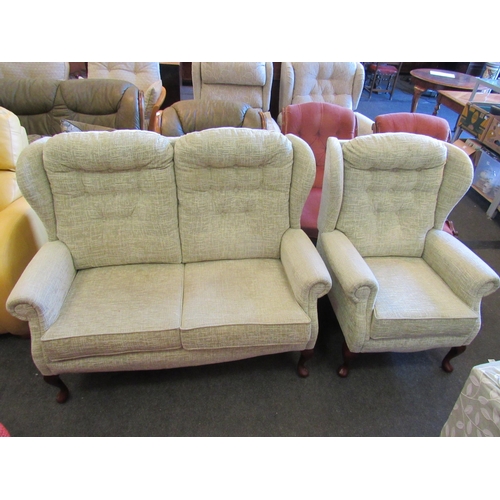 1137 - A modern two seater wingback sofa with button back on cabriole fore legs and a matching armchair    ... 