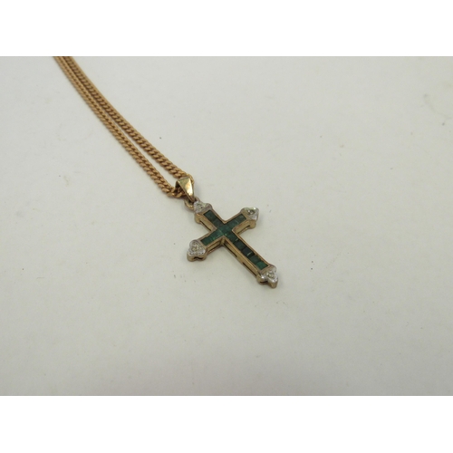 1269 - A 9ct gold emerald and diamond chips crucifix on 9ct chain