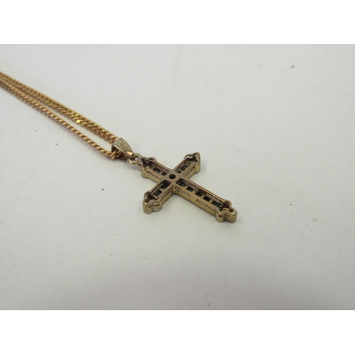 1269 - A 9ct gold emerald and diamond chips crucifix on 9ct chain