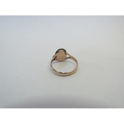 1304 - A gold ring set with an oval garnet, repaired, stamped 18ct. Size I, 2.1g  (C)