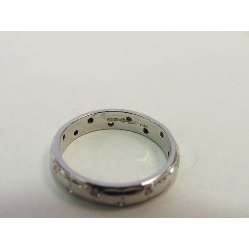 1315 - A platinum band studded with small diamonds. Size L, 5.2g