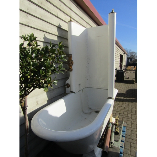 2001 - A late 19th/early 20th Century ceramic roll top bath with enamel shower splash back and brass fixing... 