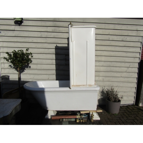 2001 - A late 19th/early 20th Century ceramic roll top bath with enamel shower splash back and brass fixing... 