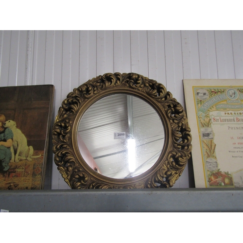 2099 - A plaster framed gilt mirror of circular form