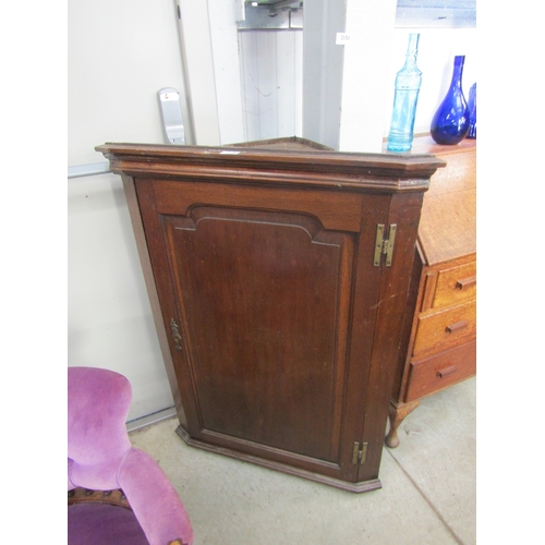 2150 - A 19th Century oak corner cupboard with shaped shelved interior    (R)  £10