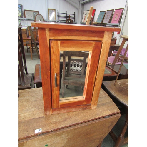 2207 - An Eastern hardwood and mirror door cabinet