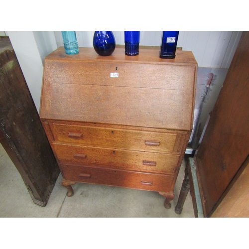 2212 - A 1940's oak three drawer bureau