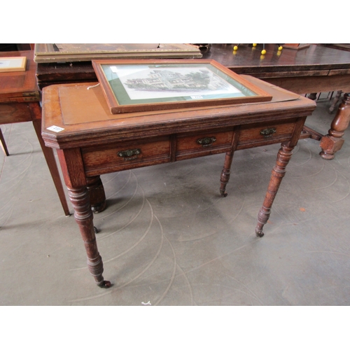 2227 - An Edwardian games table, with fold over swivel top over three drawers turned legs on porcelain cast... 