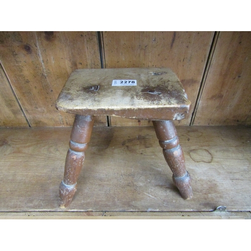 2278 - A small 19th Century milking stool with turned legs and an old repairs