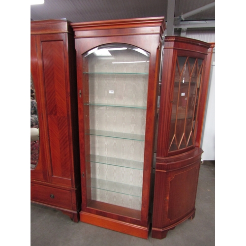 2304 - A yew veneer full height cabinet, silk backing, single glazed door and plinth base