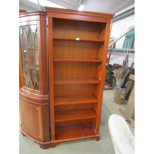 2306 - A full height 20th Century bookcase dentil freige on bracket feet