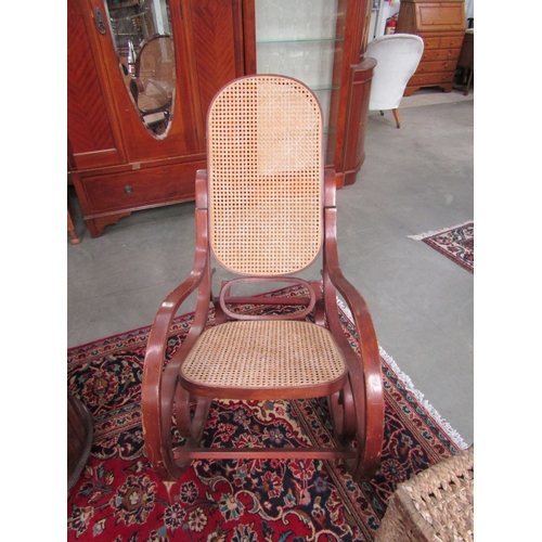 2307 - A bentwood rocking chair with a cane seat and back