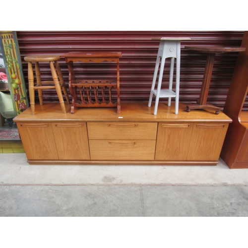 2345 - A teak Meredew low sideboard, two drawers flanked by twin cupboards