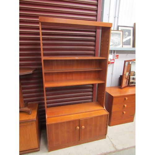 2346 - A teak full height book shelf, three shelves over twin cupboard drawers