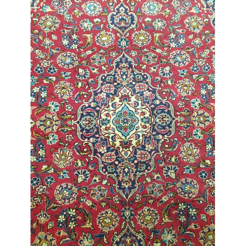 2315 - A multicoloured wool fringed carpet, maroon ground blue borders, 350m 245cms