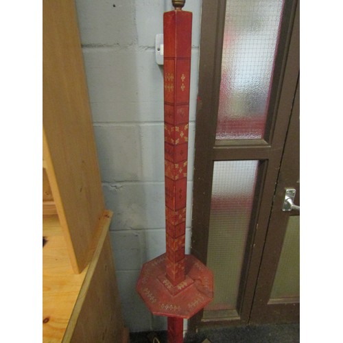 1039 - A red leather effect covered floor lamp with middle shelf and gilt detailing, 151cm high (worn)     ... 