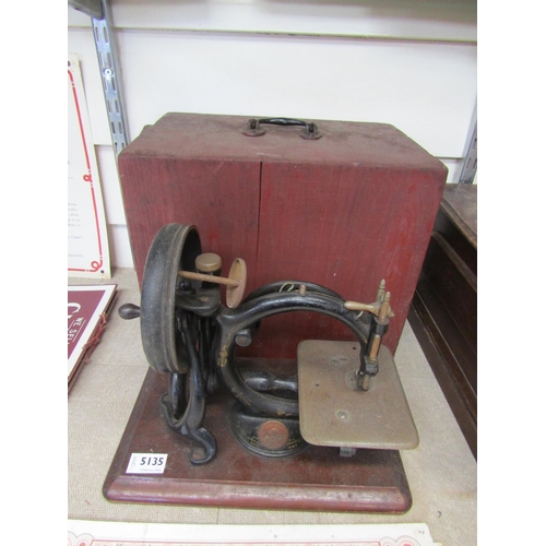 5135 - A wooden cased Wilcox & Gibbs sewing machine