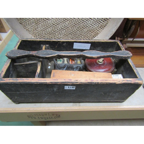 5140 - A wooden tool box and contents including iron horse head coat hooks, leather cased tape, screws etc