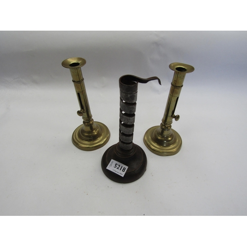 5218 - A pair of brass ejector candle sticks and a 'rat de cave' candlestick