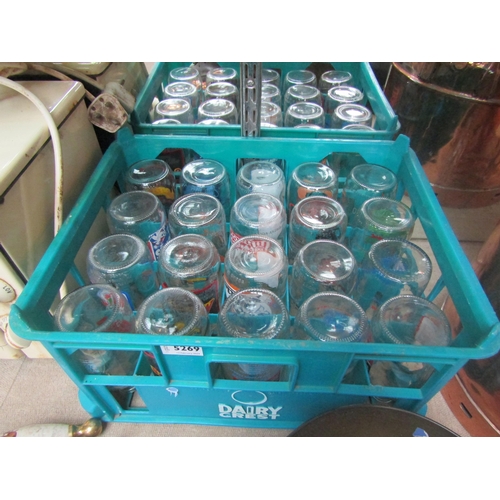 5269 - A plastic bottle crate containing 20 advertising milk bottles