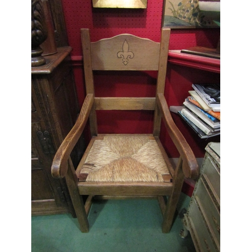 4041 - A pair of oak carver dining chairs with scrolled arms, rush seats on 'H' stretcher base