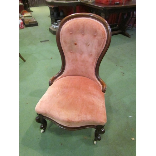 4066 - An early Victorian mahogany spoon back salmon pink upholstered armchair, the button back rest over a... 