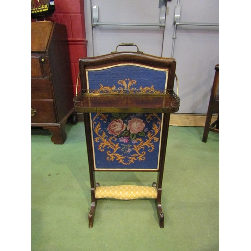 4145 - A 19th Century mahogany and brass firescreen with drinks tray and tapestry back, 86cm tall