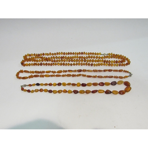 4352 - An opera length string of amber beads and two further examples (3)