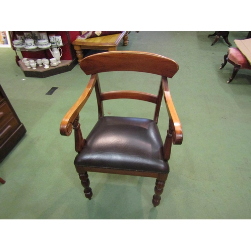 4002 - A Victorian style walnut desk armchair with scroll arms over turned and tapering fore legs