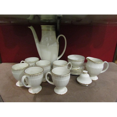 4005 - A Carlton ware coffee set, white ground with ribbed design and gilt embellishment. Hairline crack to... 