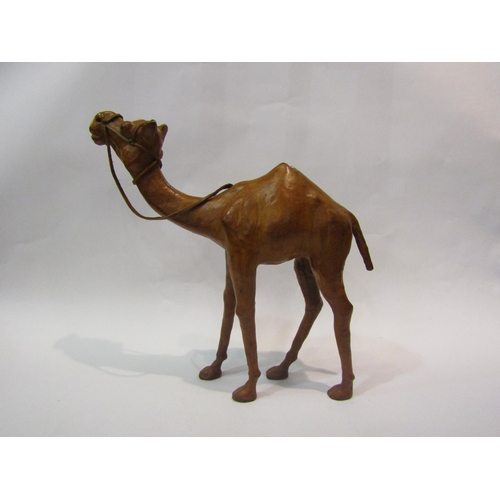4012 - A leather covered camel, 32cm tall