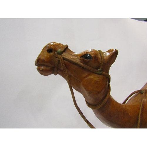 4012 - A leather covered camel, 32cm tall
