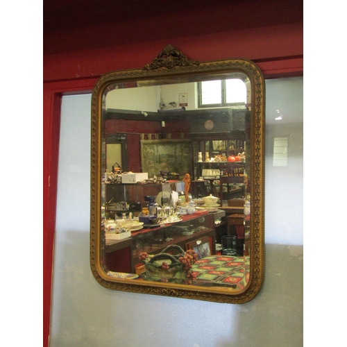 4014 - A bevel edged gilt framed wall mirror 65cm high