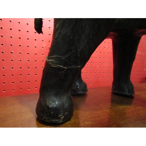 4024 - A leather elephant, rear leg a/f, 22cm high x 28cm long